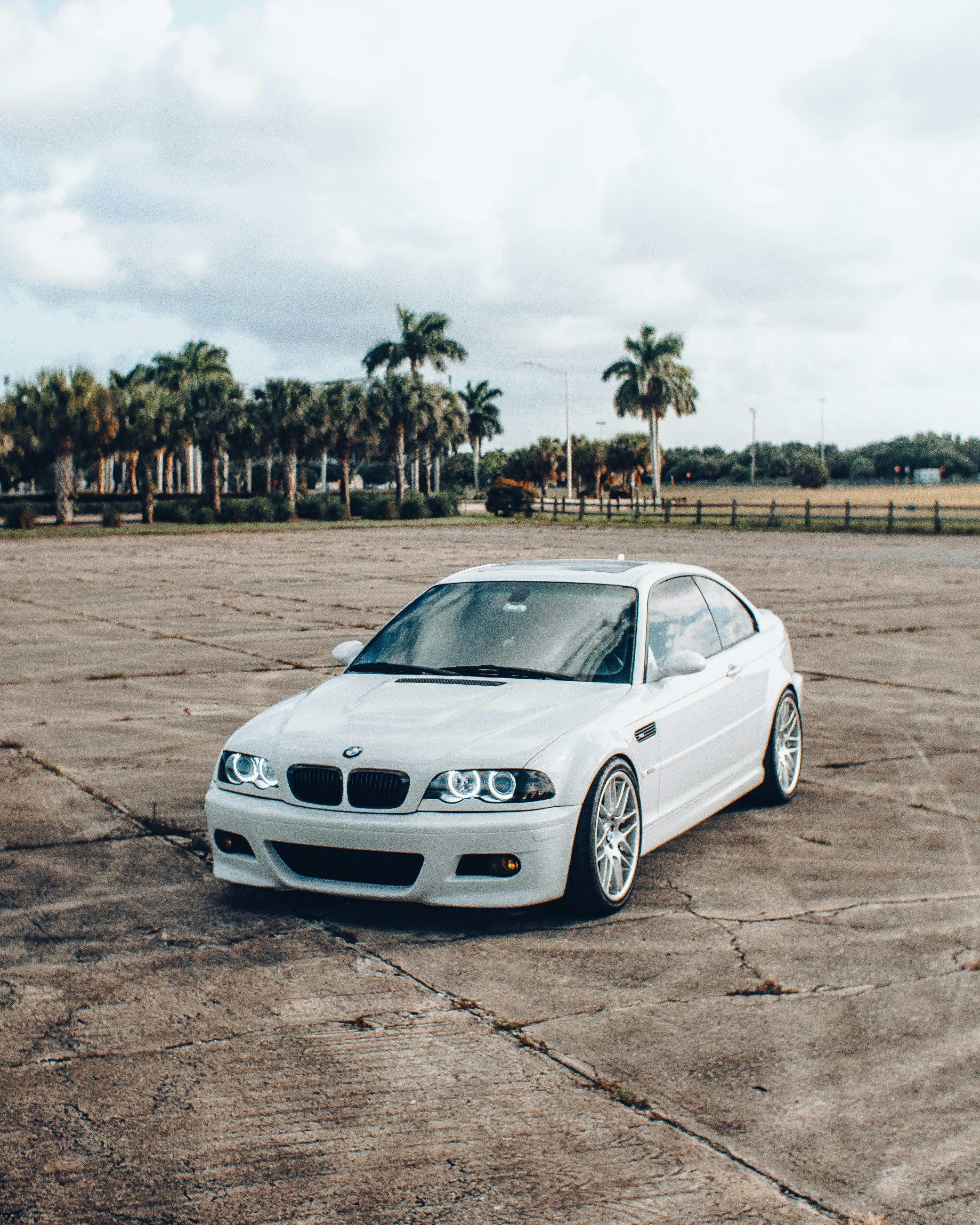 white bmw m 3 coupe on brown field during daytime